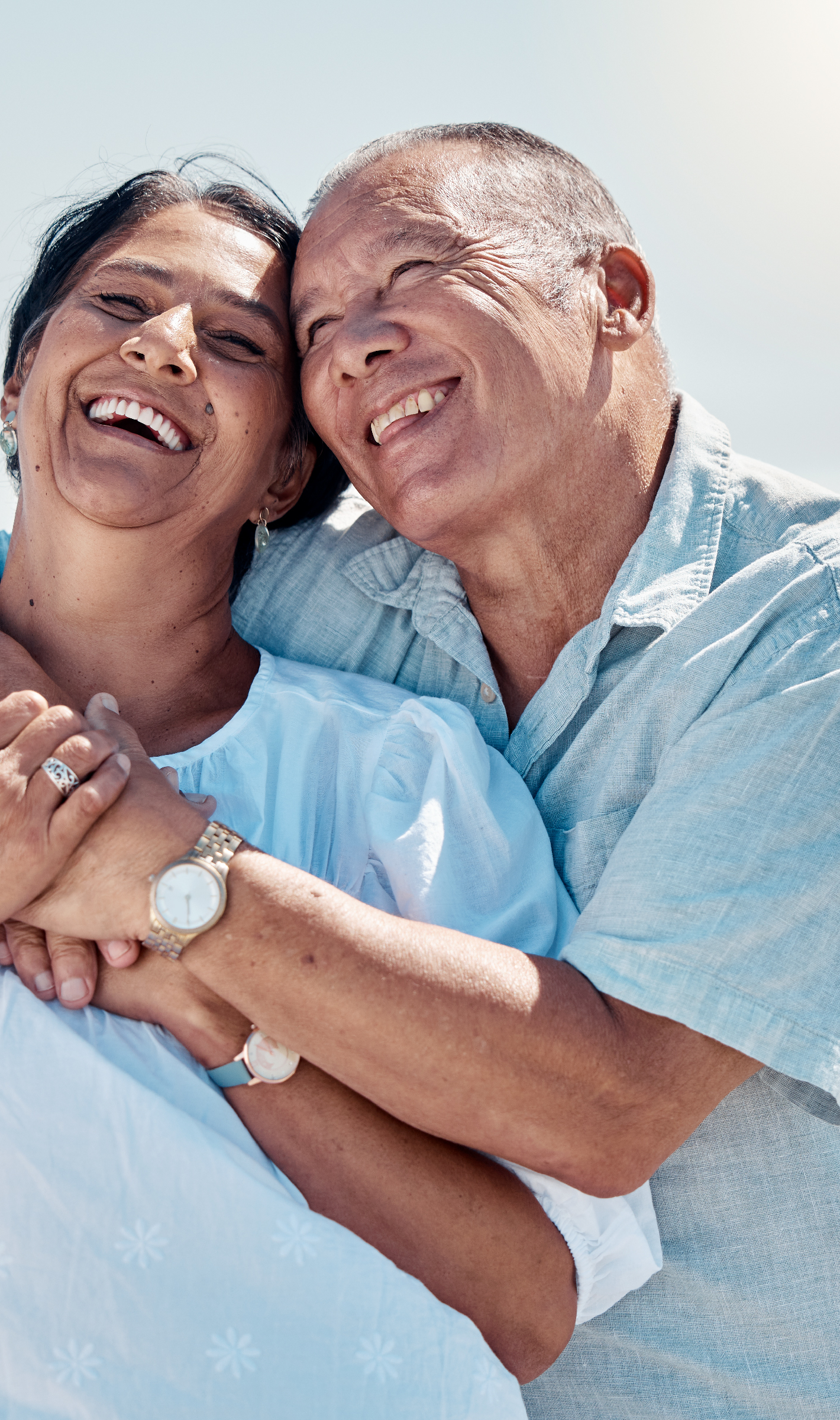 two people smiling hugging